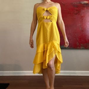 Cute polka dot cut out goldenrod dress with bow detail. Size L.